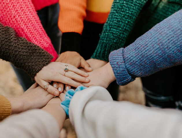 People put their hands together in a show of social support.