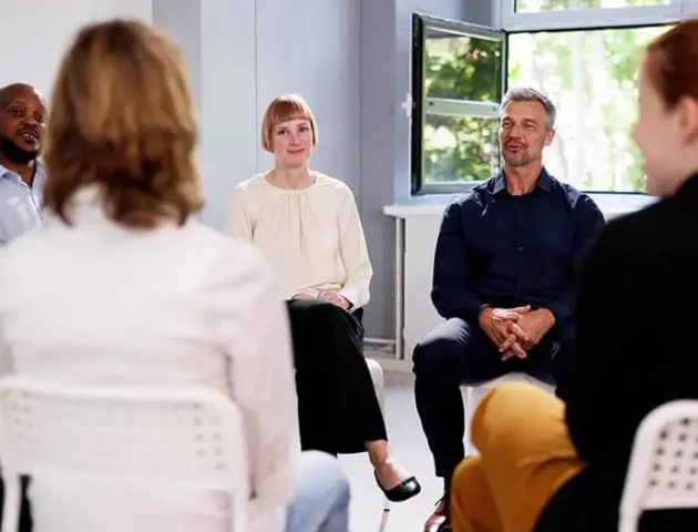 People participate in therapy at a drug rehab.