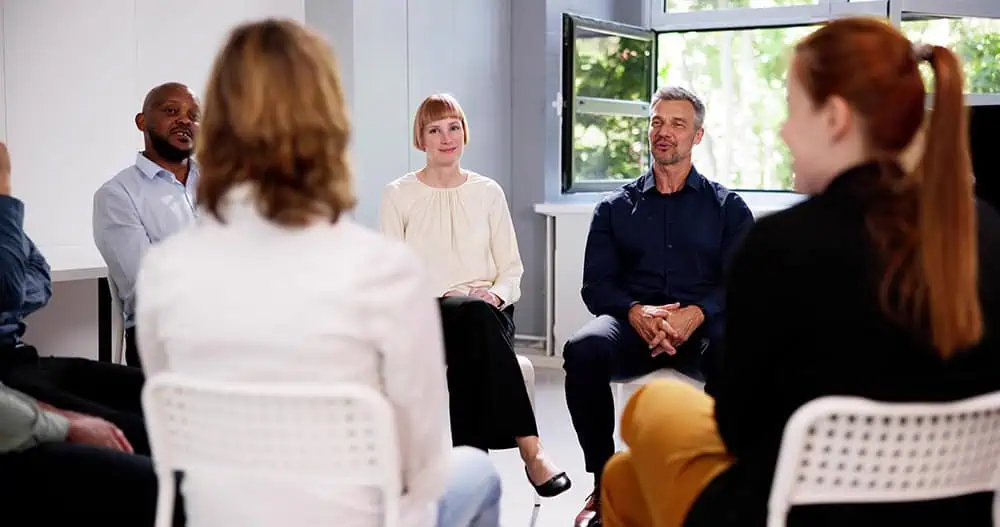 People participate in therapy at a drug rehab.